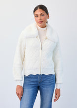 Load image into Gallery viewer, Woman wearing a white quilted sweater/jacket and blue jeans on a light gray background
