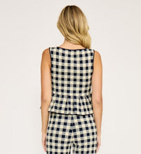 Load image into Gallery viewer, Woman wearing a Navy and white checkered jumpsuit on a plain background
