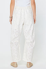 Load image into Gallery viewer, White Barrel Relaxed Fit Pants with subtle embroidered pattern worn by a person on a white background
