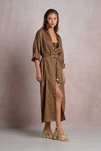 Load image into Gallery viewer, Woman wearing a brown dress with a slit on a plain background
