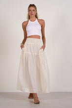 Load image into Gallery viewer, Woman wearing a white top and cream skirt against a plain background
