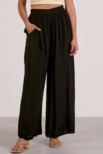 Load image into Gallery viewer, Person wearing black wide-leg pants on a plain background
