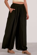 Load image into Gallery viewer, Person wearing black wide-leg pants on a white background
