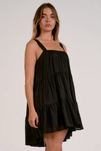 Load image into Gallery viewer, Woman wearing a black dress against a plain background
