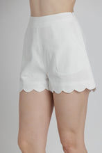 Load image into Gallery viewer, White shorts with scalloped hem on a plain background
