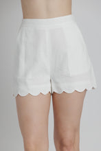 Load image into Gallery viewer, White shorts with scalloped hem on a gray background
