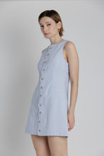 Load image into Gallery viewer, Woman wearing a light blue dress with buttons on a plain background
