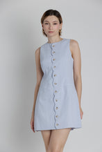 Load image into Gallery viewer, Woman wearing a light blue sleeveless dress with buttons on a plain background
