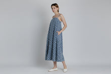 Load image into Gallery viewer, Woman wearing a blue polka dot dress on a plain background
