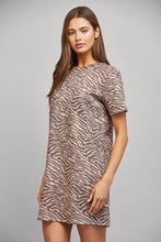 Load image into Gallery viewer, Woman wearing a zebra print dress against a gray background
