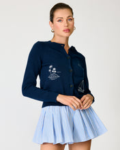 Load image into Gallery viewer, Navy Blue Sweater with Embroidery of palm trees and a sail boat. Girl with White background wearing baby blue shorts with the sweater.
