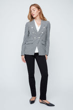 Load image into Gallery viewer, Woman wearing a checkered blazer over a white shirt with black pants on a white background.
