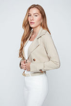 Load image into Gallery viewer, Woman wearing a beige trench coat on a white background.  Unzipped to make a crop jacket.
