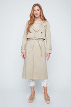 Load image into Gallery viewer, Woman wearing a beige trench coat on a white background. One button closure and tie waist.
