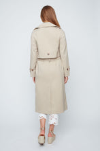 Load image into Gallery viewer, Woman wearing a beige trench coat on a white background. One button closure and tie waist.
