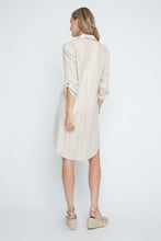 Load image into Gallery viewer, Woman wearing a golden colored dress on a white background. 3/4 length sleeves. Button down closures. 
