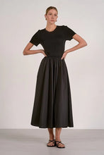 Load image into Gallery viewer, Woman wearing a black dress against a white background
