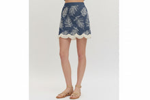 Load image into Gallery viewer, Denim skirt with white leaf pattern and beige  sandals on a plain background
