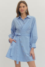 Load image into Gallery viewer, Woman wearing a French blue Mini dress with Wrap design and long sleeves on a plain background
