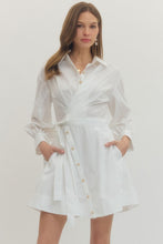 Load image into Gallery viewer, Woman wearing a white Mini dress with Wrap design and long sleeves on a plain background
