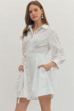 Load image into Gallery viewer, Woman wearing a white Mini dress with Wrap design and long sleeves on a plain background
