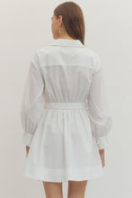 Load image into Gallery viewer, Woman wearing a white Mini dress with Wrap design and long sleeves on a plain background
