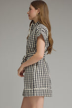 Load image into Gallery viewer, Woman wearing a black and white checkered dress against a gray background
