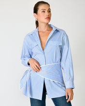 Load image into Gallery viewer, Woman wearing a blue striped shirt with a white apron over it on a plain background
