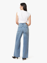 Load image into Gallery viewer, Model wearing a white sleeveless stop on a white background with straight legged blue jeans on.
