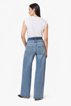 Load image into Gallery viewer, A woman shown from the back wearing light-wash blue wide-leg jeans and a white sleeveless top, photographed against a plain light gray studio background.
